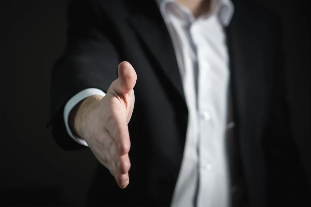 A handshake representing successful lead generation with the support of a virtual assistant.